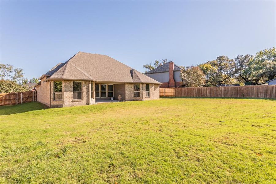 Rear view of property featuring a patio area and a yard