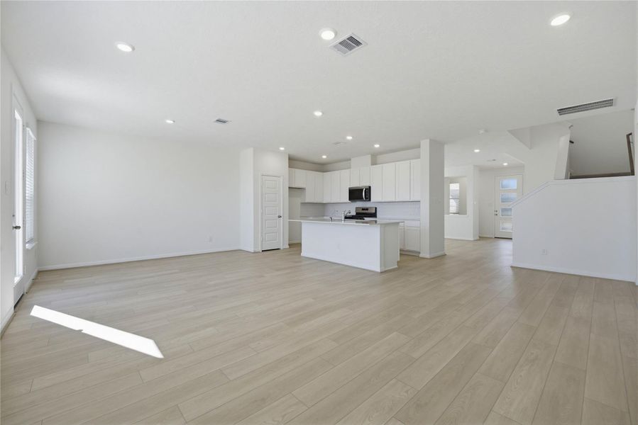 Beautiful open-concept layout effortlessly uniting the family, dining, and kitchen spaces—ideal for everyday comfort and entertaining guests!