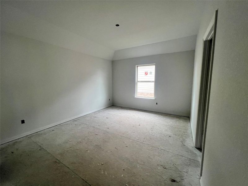 Spare room with vaulted ceiling