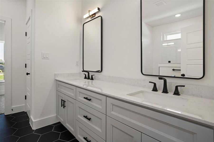 Bathroom featuring tile patterned flooring and dual bowl vanity