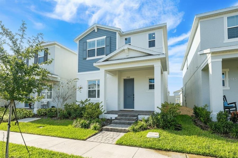 Front exterior of a new home in Osprey Ranch, Winter Garden, FL, highlighting curb appeal (Image 1). Front exterior of a new home in Osprey Ranch, Winter Garden, FL, highlighting curb appeal (Image 1).