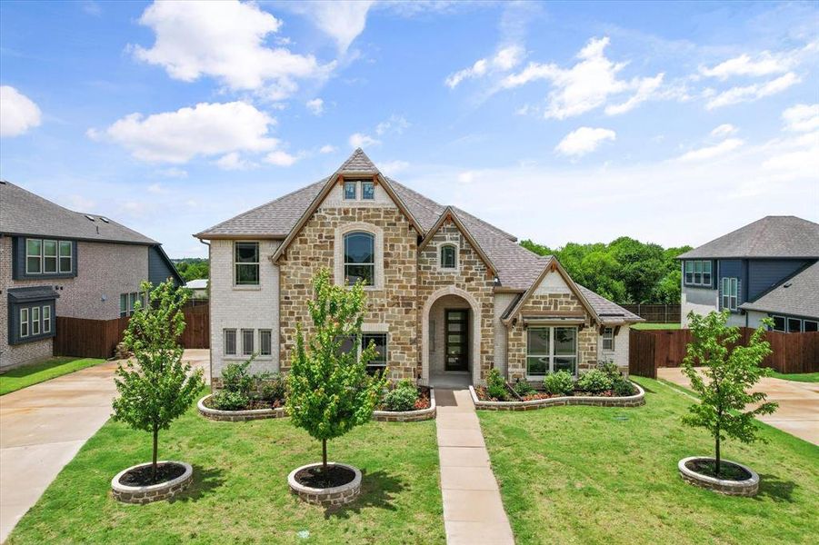 Front exterior of a new home in Wind Ridge, Midlothian, TX, highlighting curb appeal (Image 1). Front exterior of a new home in Wind Ridge, Midlothian, TX, highlighting curb appeal (Image 1).