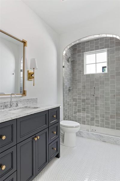 Full bath featuring vanity, a shower stall, and light tile patterned floors Full bath featuring vanity, a shower stall, and light tile patterned floors