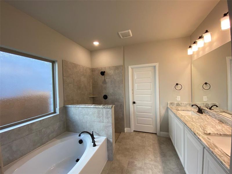 Spa-like master bath with separate garden tub & shower and 12x24 tile