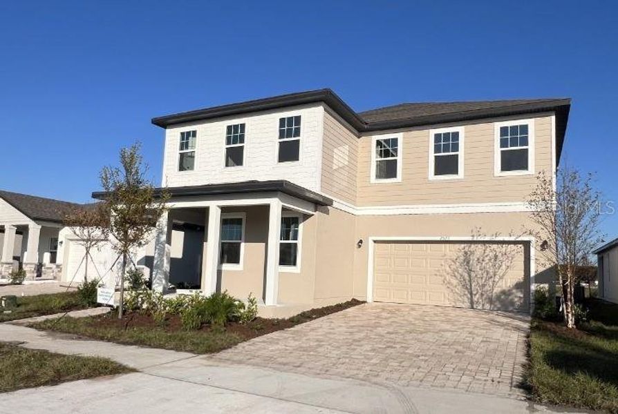 Front exterior of a new home in Hawks Run, Kissimmee, FL, highlighting curb appeal (Image 17). Front exterior of a new home in Hawks Run, Kissimmee, FL, highlighting curb appeal (Image 17).
