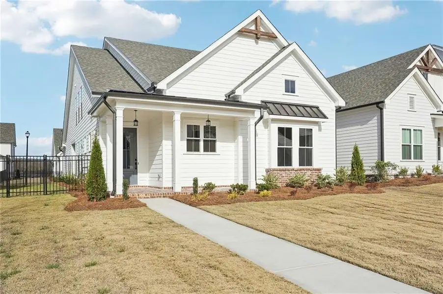 Front exterior of a new home in Promenade at Sawnee Village, Cumming, GA, highlighting curb appeal (Image 1). Front exterior of a new home in Promenade at Sawnee Village, Cumming, GA, highlighting curb appeal (Image 1).