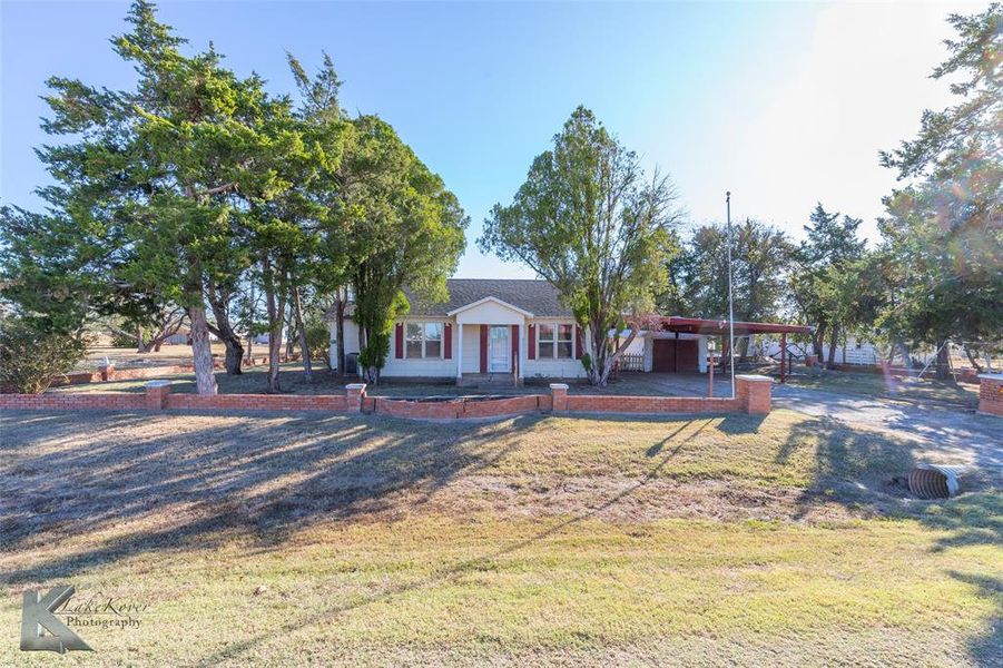 View of front of property featuring a carport, a front lawn, and a porch View of front of property featuring a carport, a front lawn, and a porch