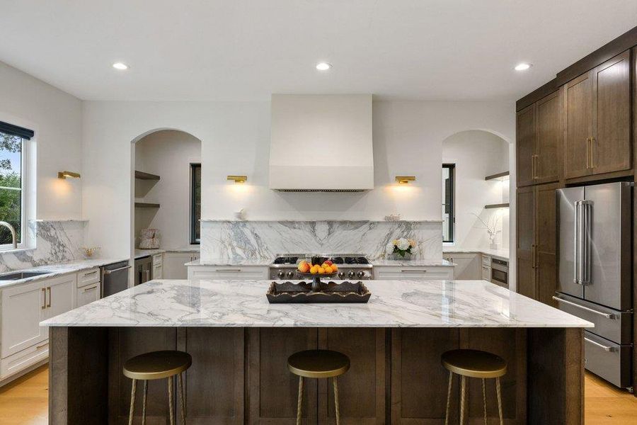 A gourmet kitchen boasts a spacious island and gleaming marble countertops, perfect for culinary adventures. A gourmet kitchen boasts a spacious island and gleaming marble countertops, perfect for culinary adventures.