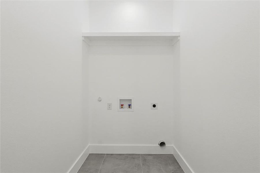 Laundry room with hookup for a washing machine, hookup for a gas dryer, light tile patterned floors, and hookup for an electric dryer