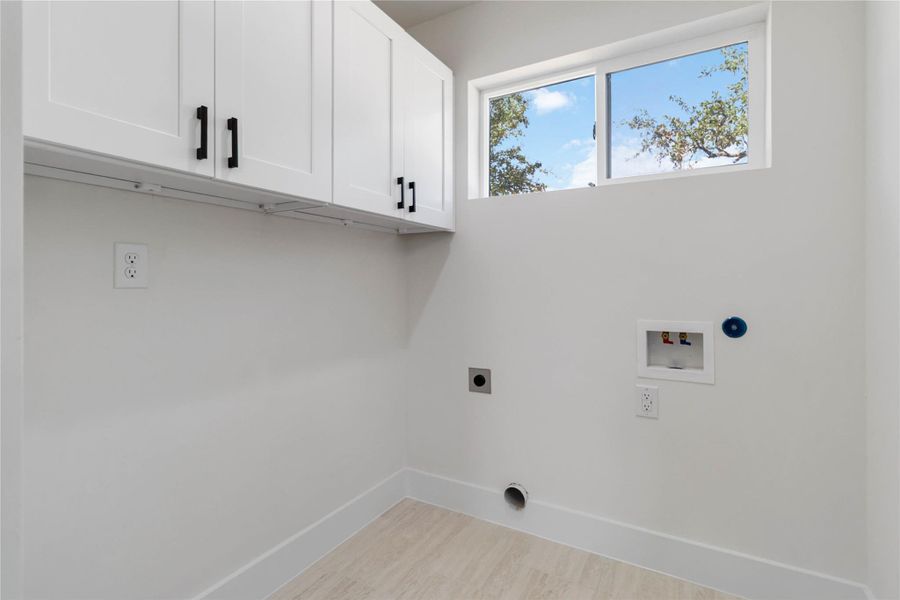 Dedicated laundry room with pocket door on main level with convenient washer and dryer connections for everyday functionality. Dedicated laundry room with pocket door on main level with convenient washer and dryer connections for everyday functionality.