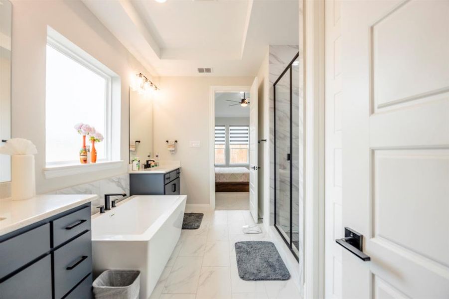 Ensuite bathroom with ensuite bath, visible vents, marble finish floor, and a shower stall