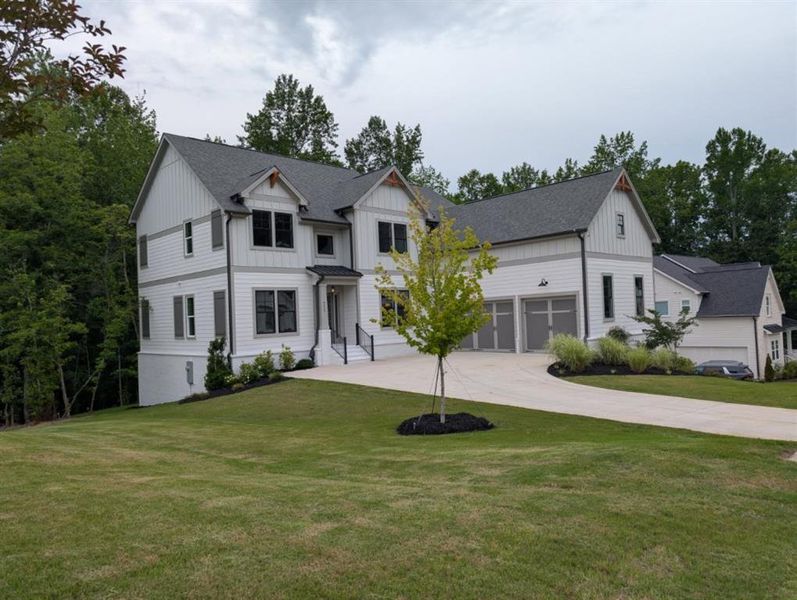 Front exterior of a new home in Arden on Lanier, Cumming, GA, highlighting curb appeal (Image 21). Front exterior of a new home in Arden on Lanier, Cumming, GA, highlighting curb appeal (Image 21).
