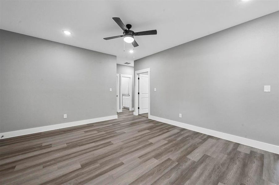 Unfurnished room with ceiling fan and light hardwood / wood-style flooring