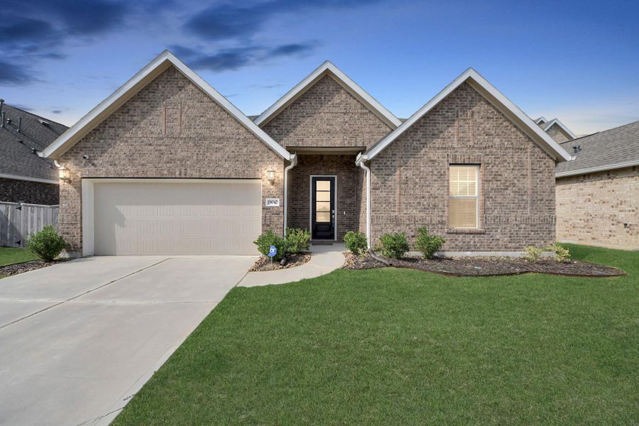 Front exterior of a new home in Tavola: Fairway Collection, New Caney, TX, highlighting curb appeal (Image 1).