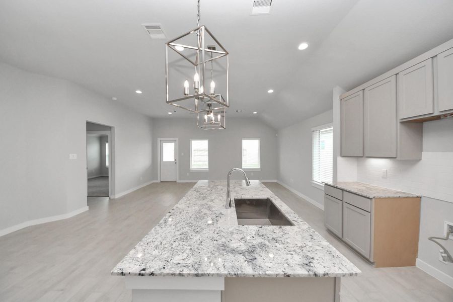 The open concept effortlessly connects the kitchen to the expansive family room, forming a perfect hub for gatherings. This seamless flow creates an inviting space where cooking and socializing come together harmoniously.