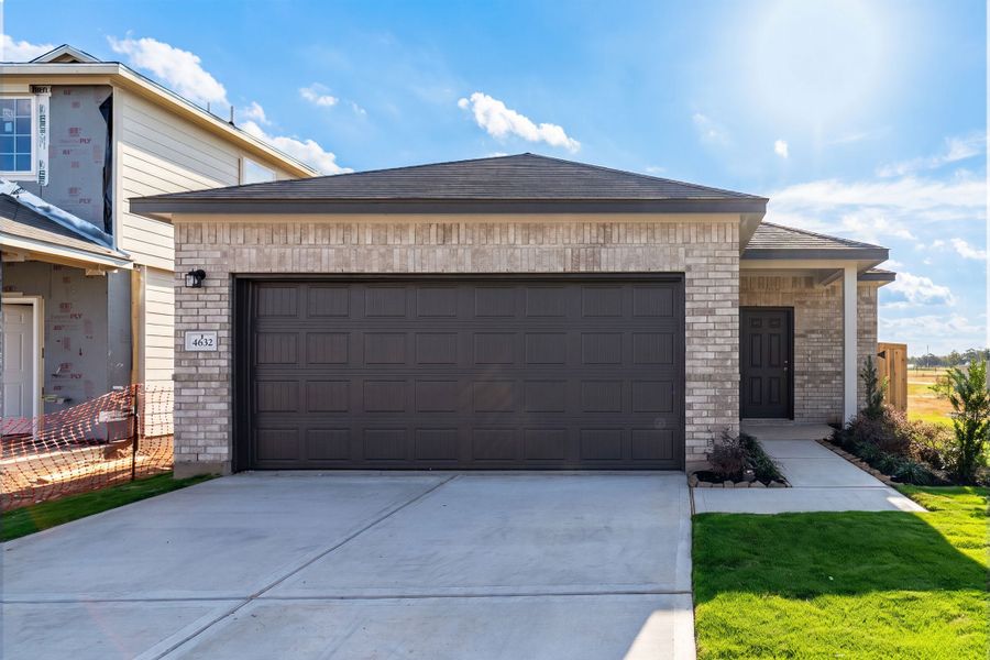 Front exterior of a new home in Colony at Pinehurst, Pinehurst, TX, highlighting curb appeal (Image 1). Front exterior of a new home in Colony at Pinehurst, Pinehurst, TX, highlighting curb appeal (Image 1).