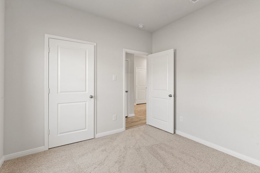 A hallway with white doors.