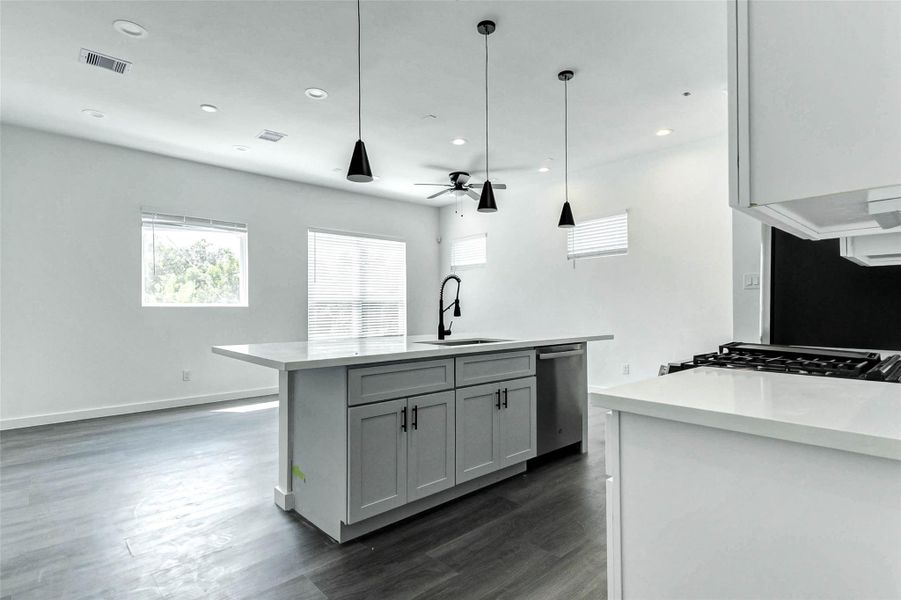 The heart of the home! This oversized island anchors the kitchen and creates effortless flow into the living and dining areas. Matte black hardware and a flood of natural light add a stylish, welcoming touch. The heart of the home! This oversized island anchors the kitchen and creates effortless flow into the living and dining areas. Matte black hardware and a flood of natural light add a stylish, welcoming touch.