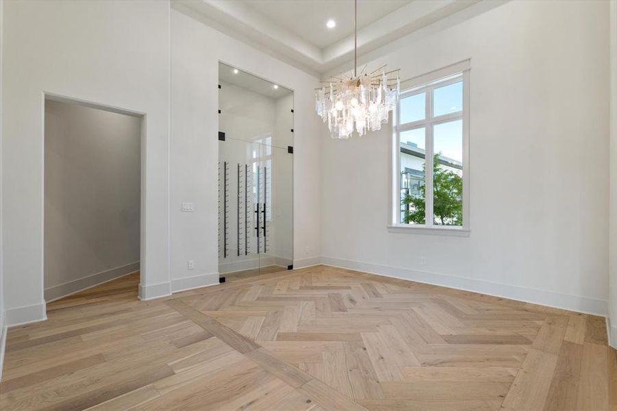 Spare room with a chandelier, recessed lighting, a towering ceiling, and a tray ceiling