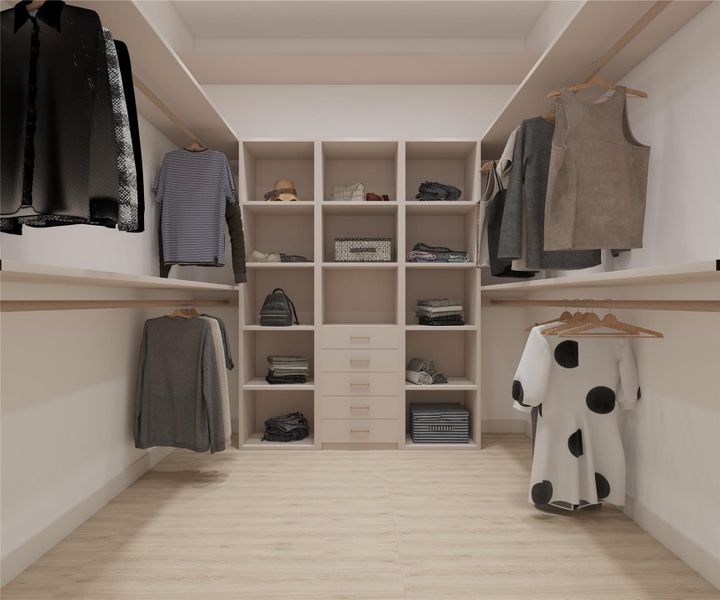 Expansive walk-in closet with custom shelving, drawers, and ample hanging space.