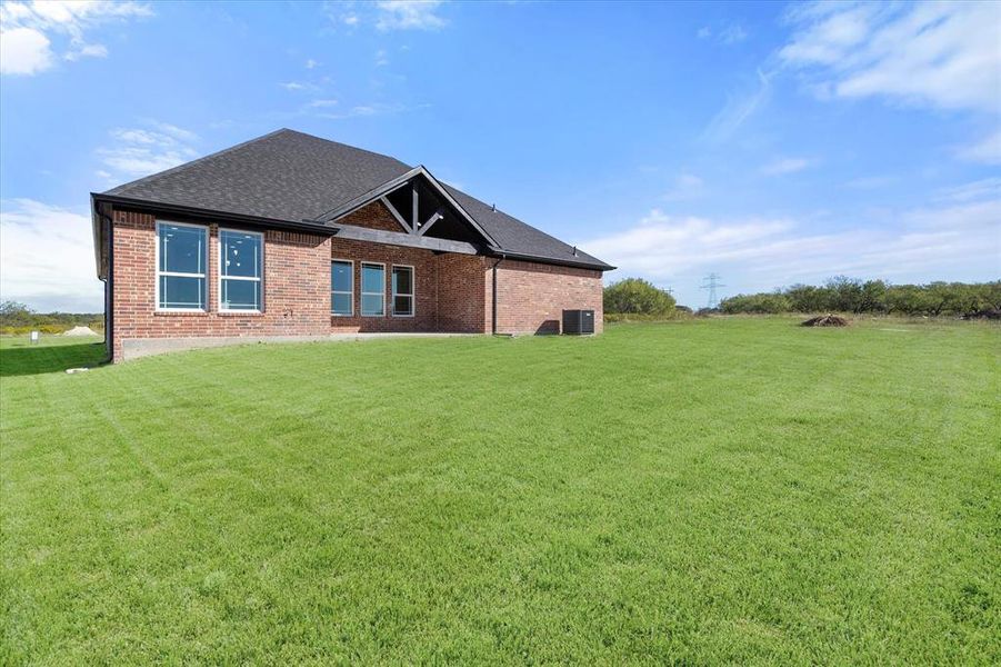 View of front facade with central AC unit and a front lawn