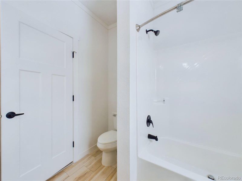 Bathroom with shower / bath combination and toilet...