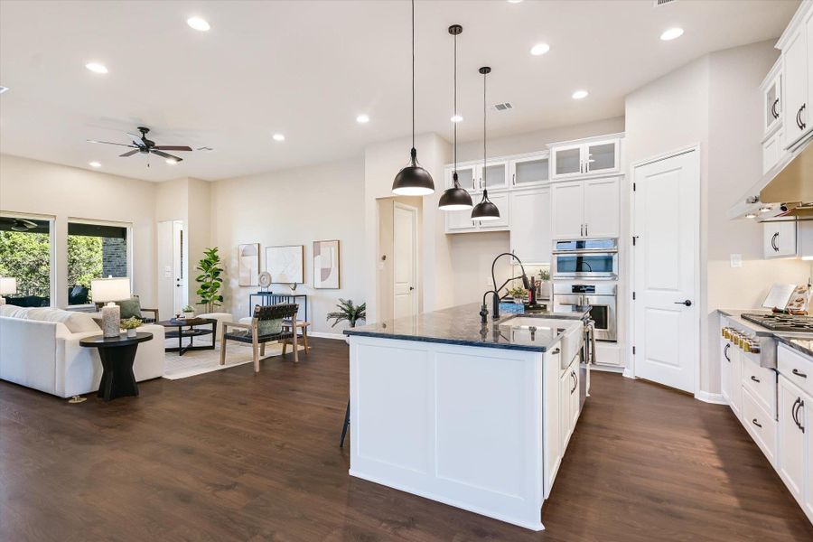 Open concept living, dining and kitchen area features beautiful Redwood® flooring.