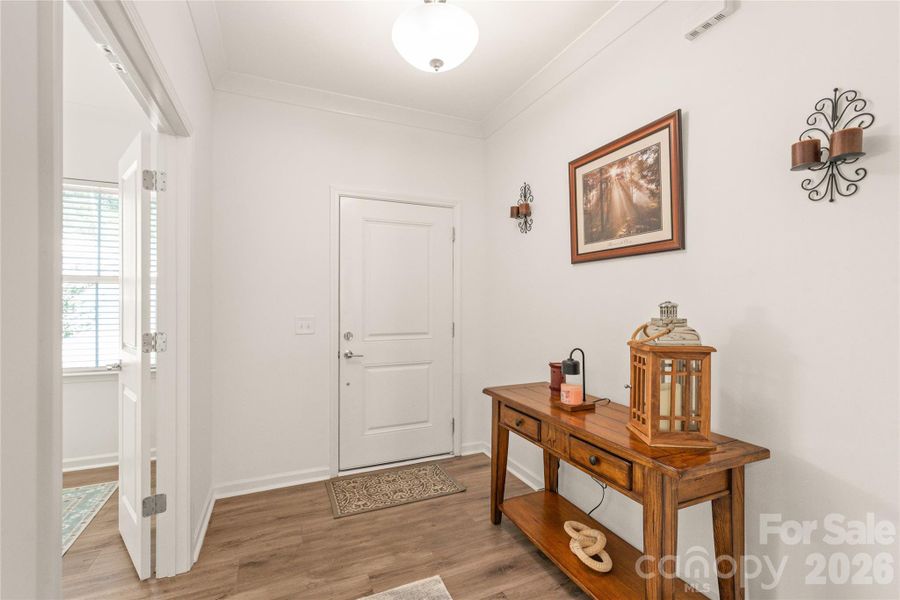 A roomy foyer with beautiful LVP flooring throughout the main level, and a double-door office/flex space to your right as you enter.