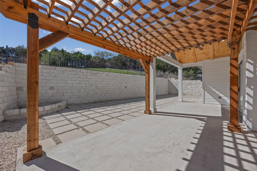 Fenced backyard with a patio area and a pergola Fenced backyard with a patio area and a pergola