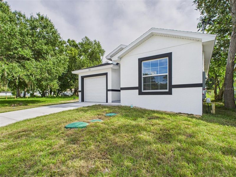 Front exterior of a new home in , Lakeland, FL, highlighting curb appeal (Image 1).