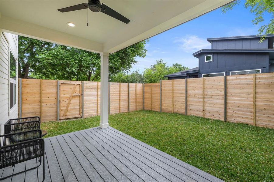 Spacious covered porch in backyard.