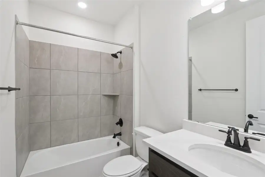 Bathroom featuring vanity and shower / tub combination