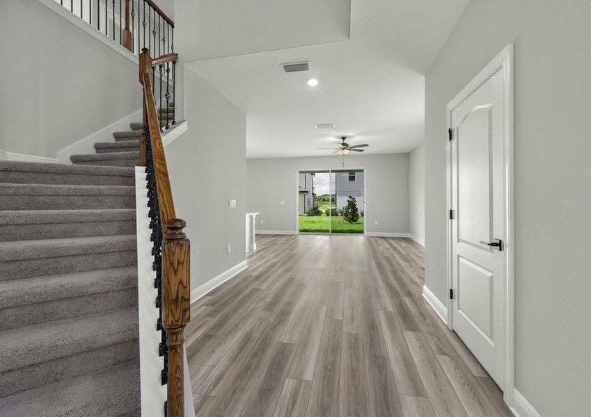 Foyer with a staircase leads to the family room