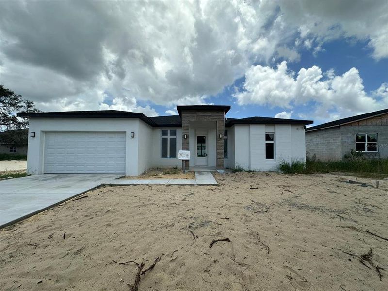 Front exterior of a new home in , Kissimmee, FL, highlighting curb appeal (Image 1). Front exterior of a new home in , Kissimmee, FL, highlighting curb appeal (Image 1).