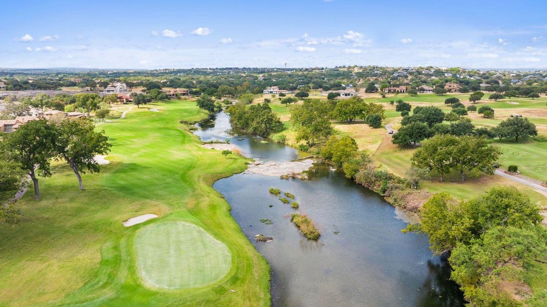 Drone / aerial view of a golf course and a large body of water
