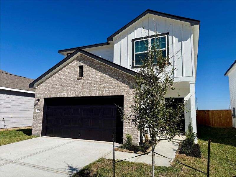 Front exterior of a new home in Royal Pines, Porter, TX, highlighting curb appeal (Image 1). Front exterior of a new home in Royal Pines, Porter, TX, highlighting curb appeal (Image 1).