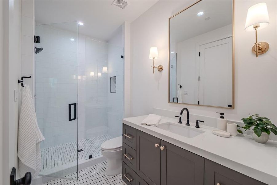 Full bath with a stall shower, vanity, recessed lighting, and light tile patterned floors Full bath with a stall shower, vanity, recessed lighting, and light tile patterned floors