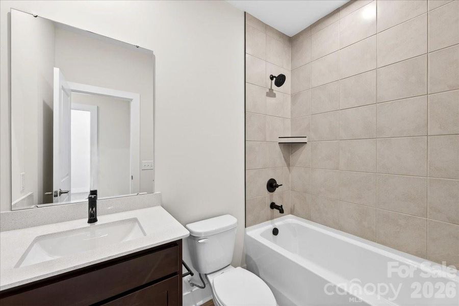 Secondary Bathroom with tiled walls above the tub