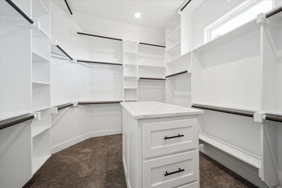 Walk in closet featuring dark colored carpet