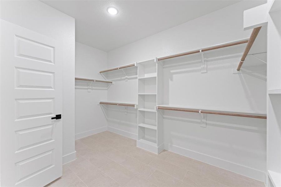 Walk in closet with light tile patterned floors Walk in closet with light tile patterned floors