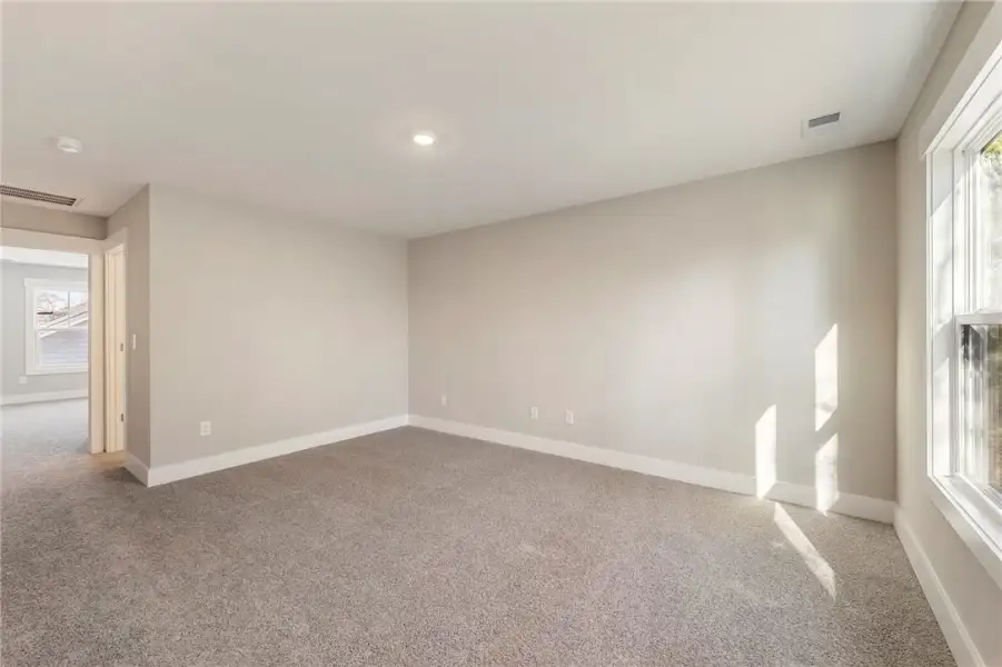 Sun-filled room with plush carpet, ideal for relax