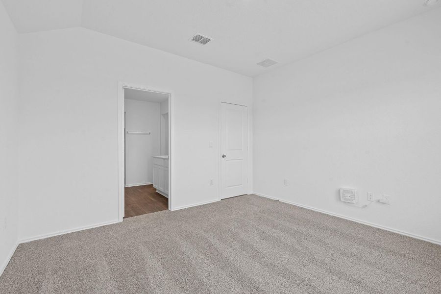 Unfurnished bedroom featuring carpet floors and ensuite bath Unfurnished bedroom featuring carpet floors and ensuite bath