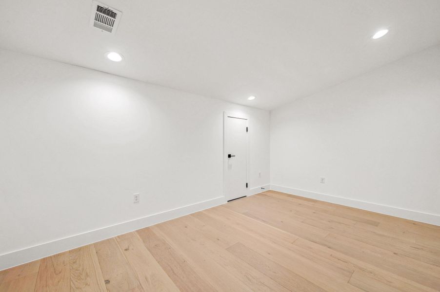 Spare room with light wood-style flooring and recessed lighting