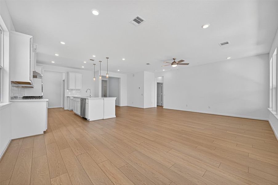 The open-concept layout seamlessly connects the kitchen, dining, and living areas, creating the perfect space for both everyday living and entertaining.