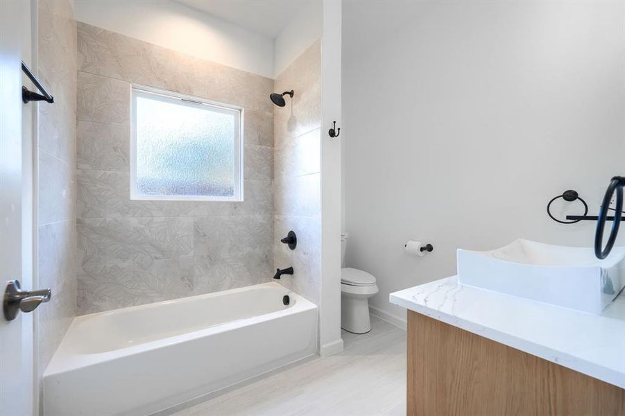 Bathroom featuring vanity and shower / tub combination