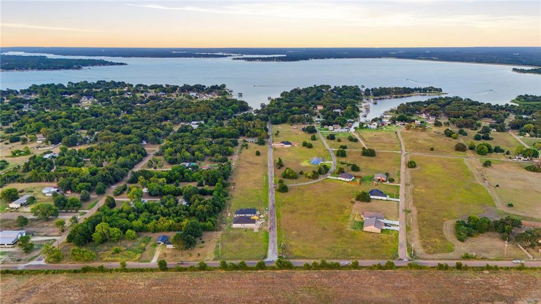 Aerial perspective showcasing a large body of water bordered by residential properties