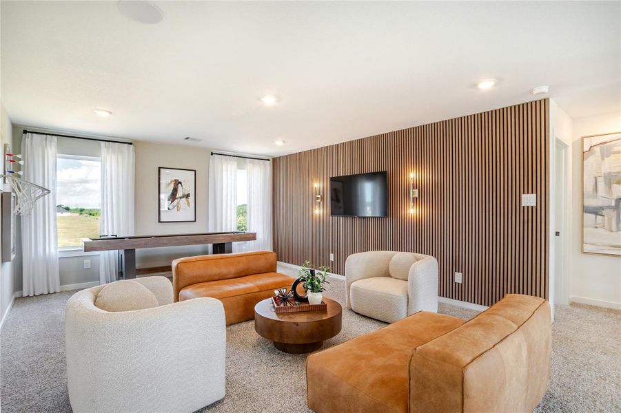 This modern living room features a cozy seating area with stylish beige and tan furniture, a wall-mounted TV, and chic wood paneling. Large windows with sheer curtains offer plenty of natural light, and there's a sleek game table for entertainment. This modern living room features a cozy seating area with stylish beige and tan furniture, a wall-mounted TV, and chic wood paneling. Large windows with sheer curtains offer plenty of natural light, and there's a sleek game table for entertainment.