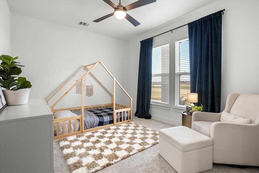 Bedroom featuring multiple windows, light carpet, and ceiling fan