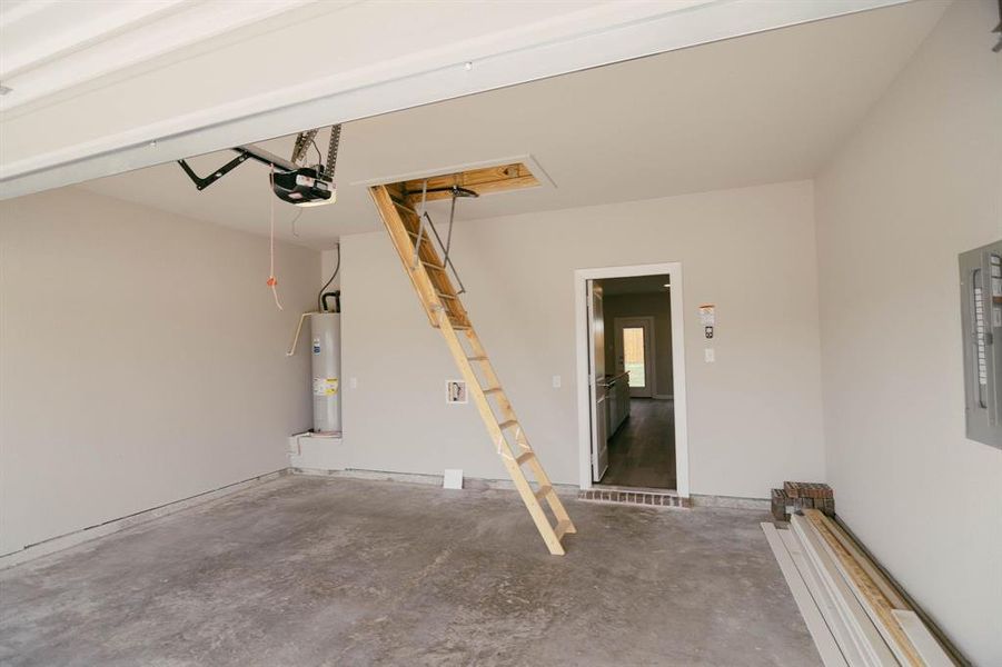 Garage with water heater and a garage door opener