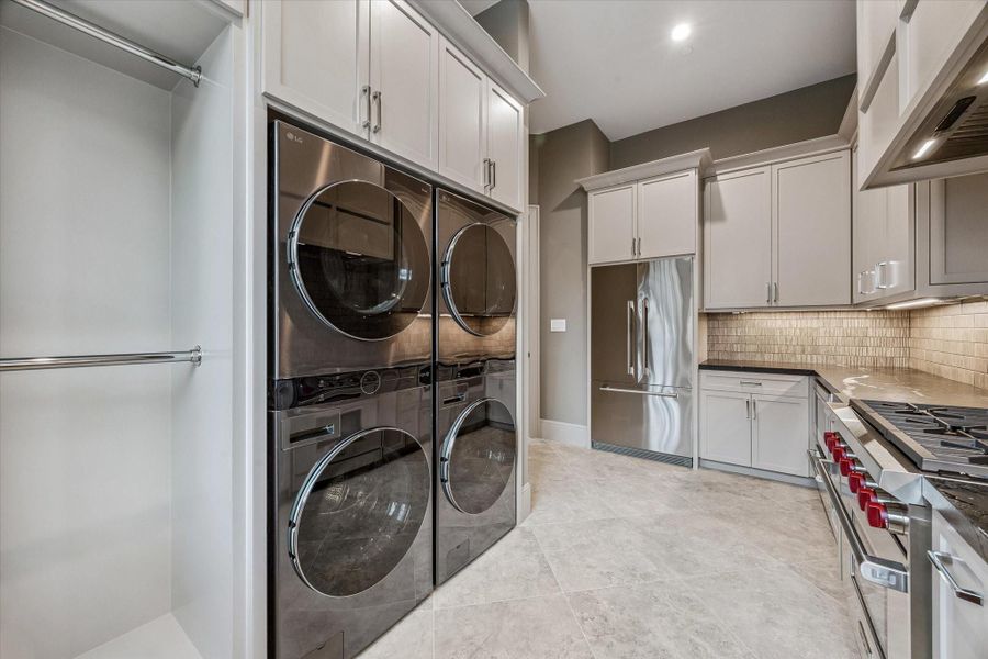 DOWNSTAIRS LAUNDRY AND CATERING KITCHEN WITH TWO FULL SETS OF WASHERS AND DRYERS